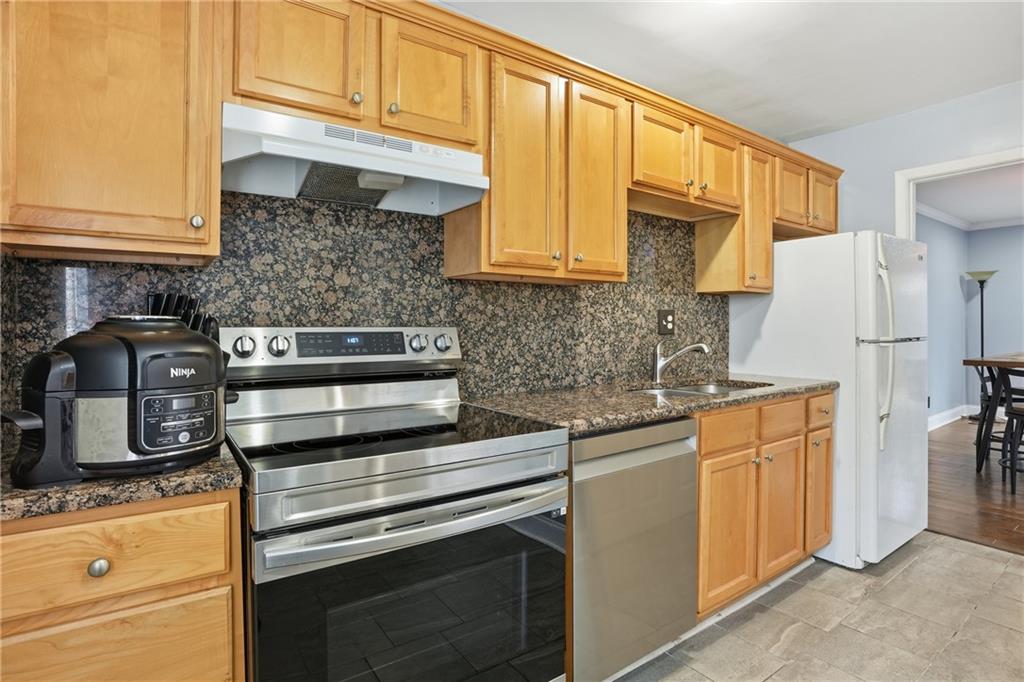 3320 Northcrest Road, Unit C Atlanta, GA 30340 - Photo 10 of 34 a kitchen with stainless steel appliances granite countertop a refrigerator sink and cabinets