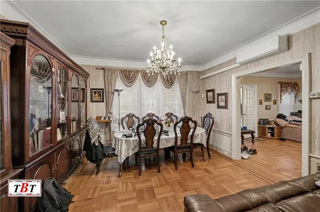 a view of a dining room with furniture and a chandelier