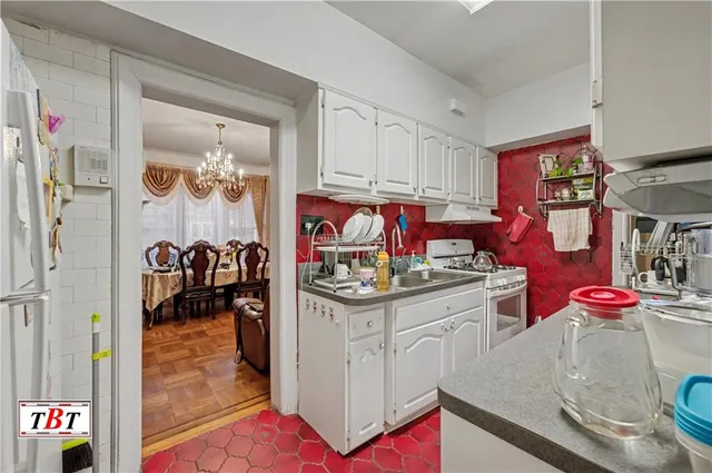 a kitchen with granite countertop a sink and cabinets