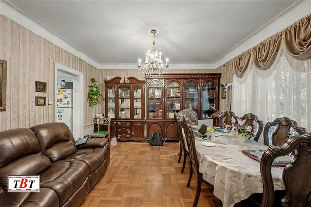 a living room with furniture and a chandelier