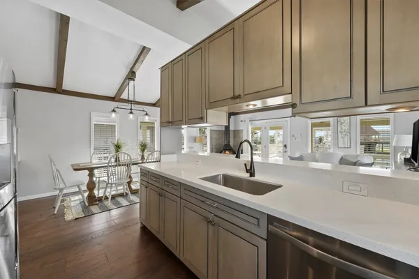 a kitchen with sink cabinets and wooden floor