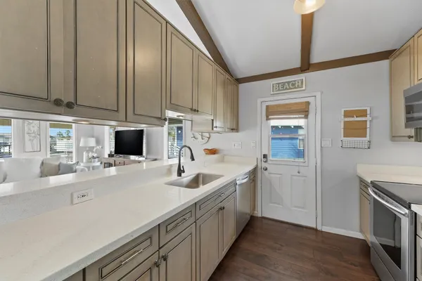a kitchen with a sink cabinets and appliances
