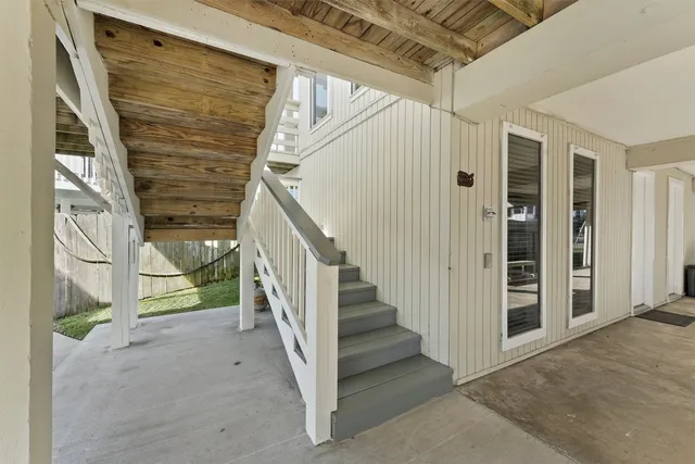 a view of staircase with white walls and windows