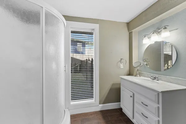 a bathroom with a sink a mirror and a shower