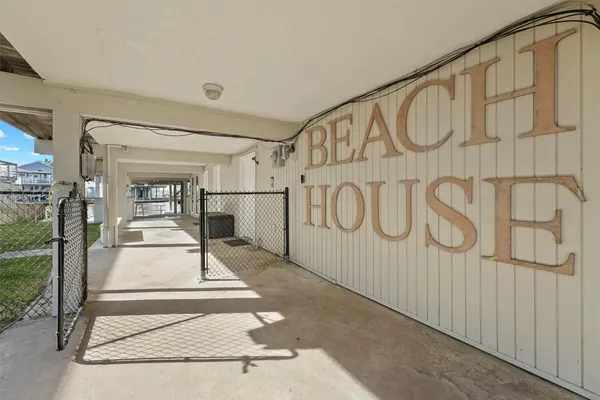 a patio with table and chairs and potted plants