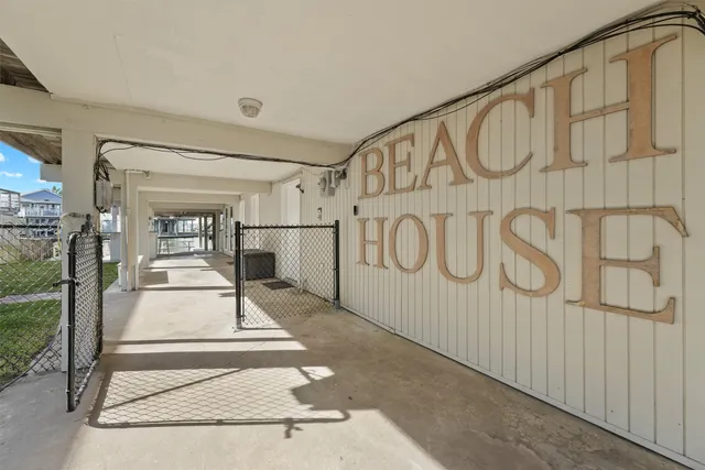 a patio with table and chairs and potted plants