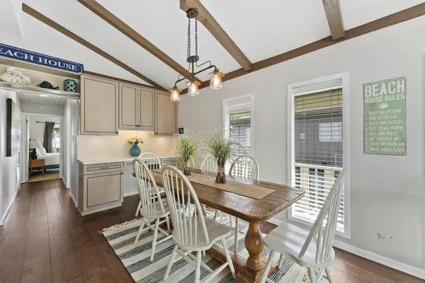 a view of a dining room with furniture and wooden floor