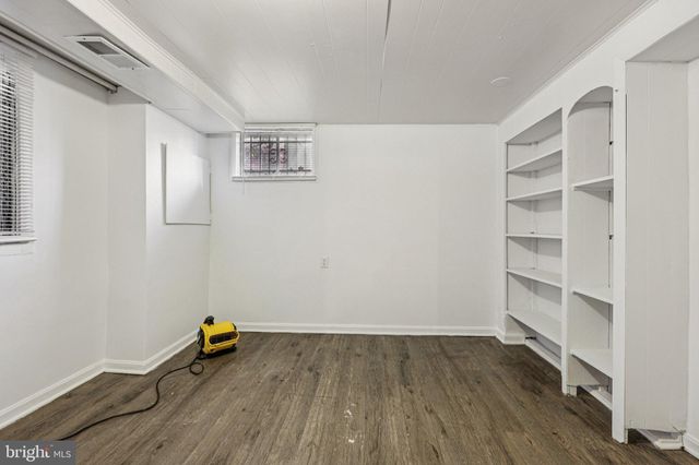 a view of a room with wooden floor and closet