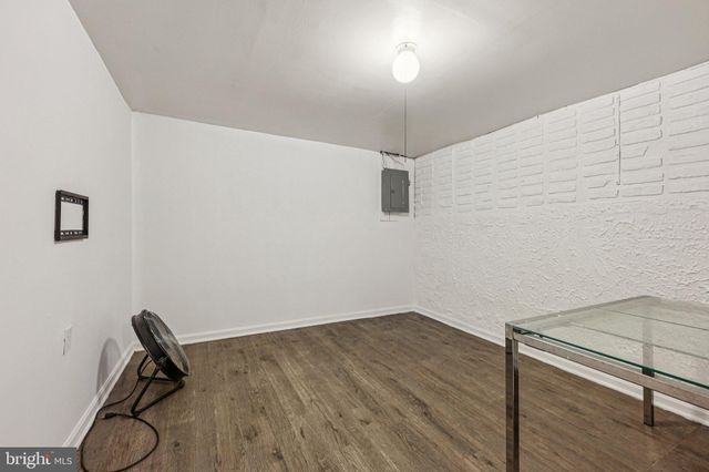 a view of a room with wooden floor and white walls