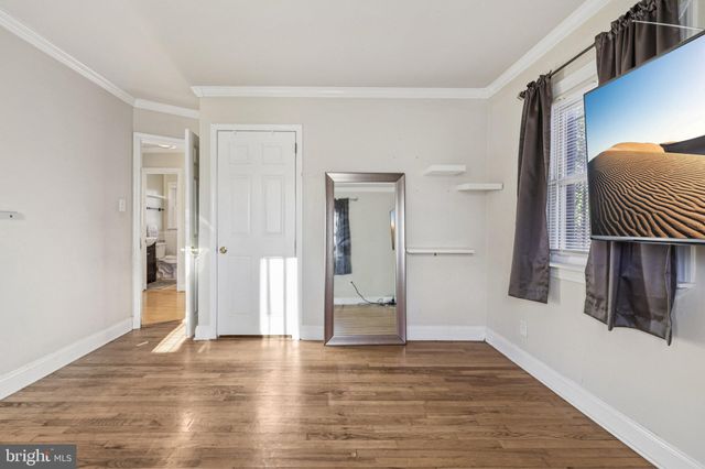 a view of an empty room and wooden floor