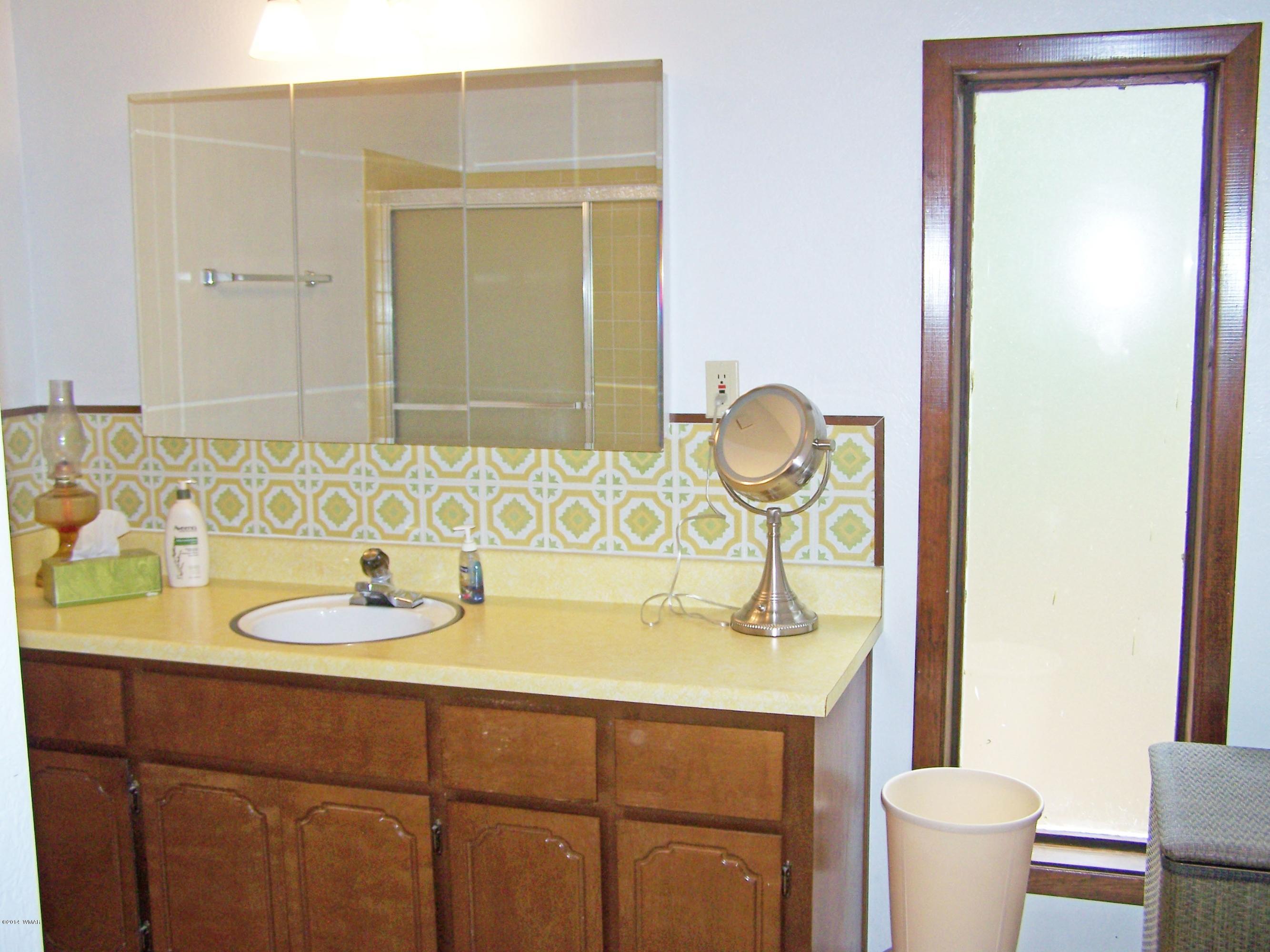7 County Road 2135 Alpine, AZ 85920 - Photo 11 of 16 a bathroom with a sink and a mirror