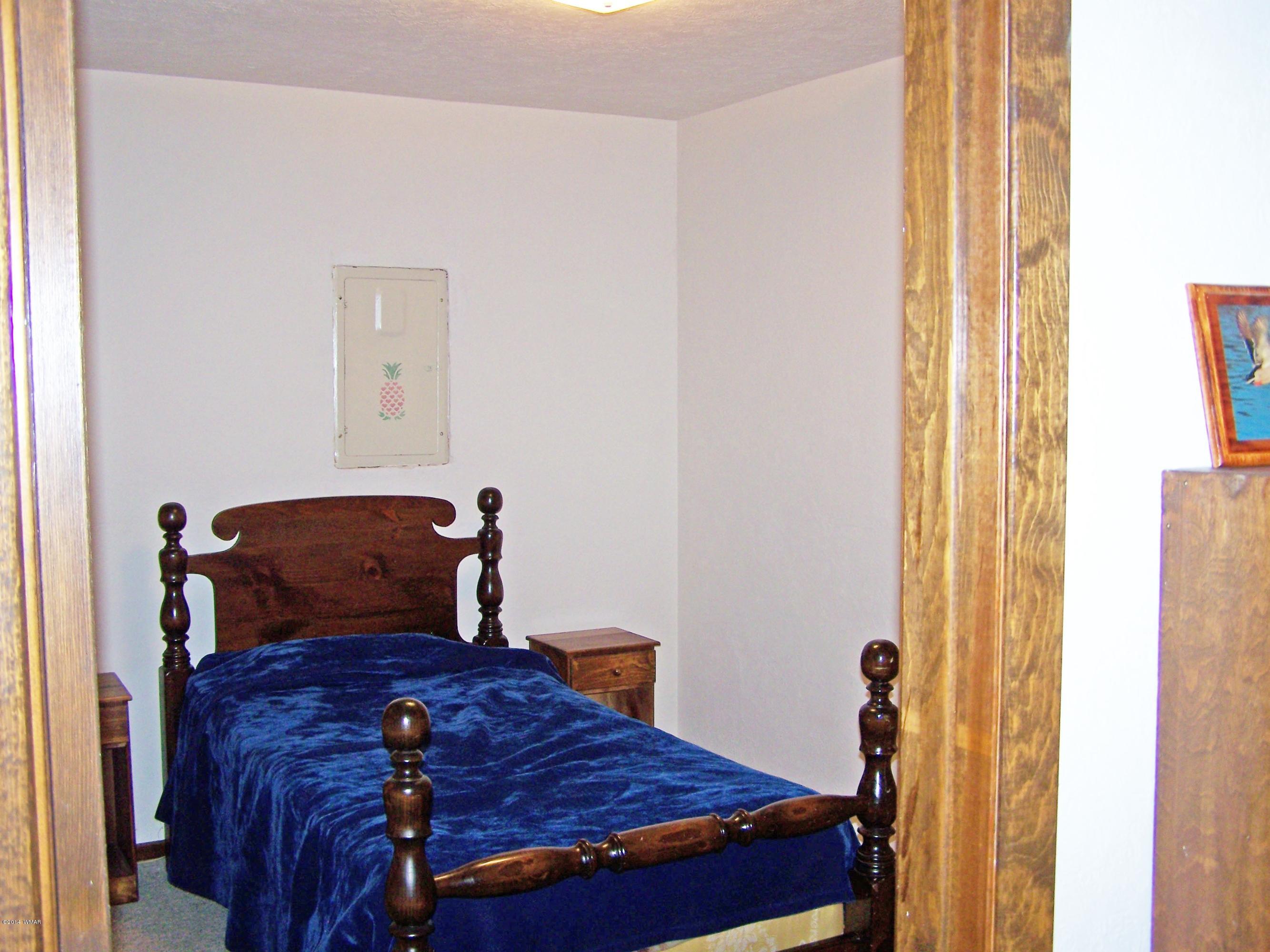 7 County Road 2135 Alpine, AZ 85920 - Photo 10 of 16 a bedroom with a bed and wooden floor