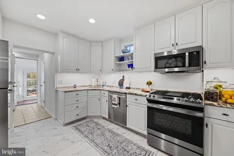 a kitchen with cabinets stainless steel appliances and wooden cabinets