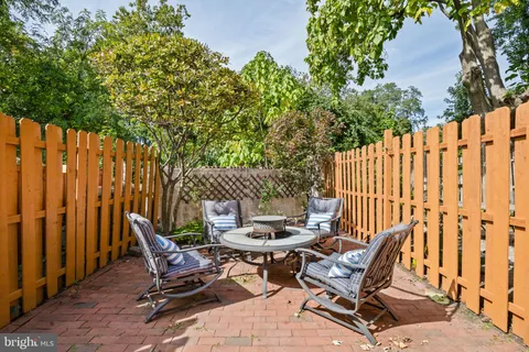 a view of a chairs and table in backyard