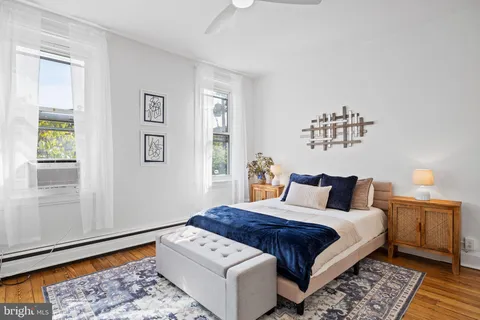 a bedroom with a large bed and a window