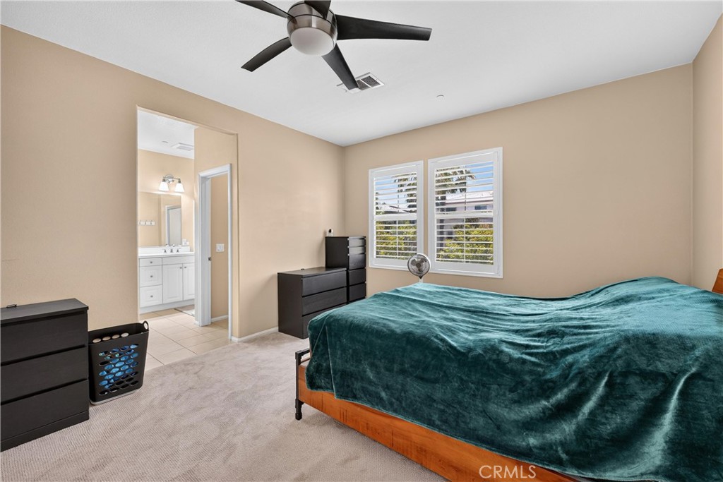 849 The Promenade, Unit D Azusa, CA 91702 - Photo 24 of 37 a bedroom with a bed and a chandelier