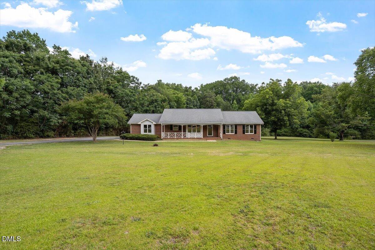805 Rand Road Garner, NC 27529 - Photo 3 of 38 a view of a swimming pool with lawn chairs under an umbrella