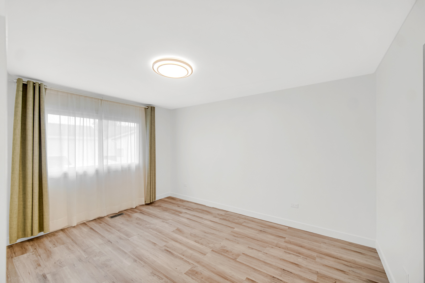 1485 Chippewa Trail Wheeling, IL 60090 - Photo 12 of 16 an empty room with wooden floor and windows