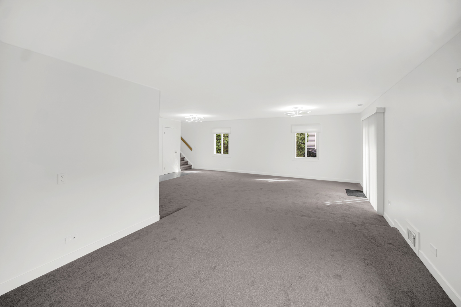 1485 Chippewa Trail Wheeling, IL 60090 - Photo 14 of 16 a view of a big room with windows and chandelier fan