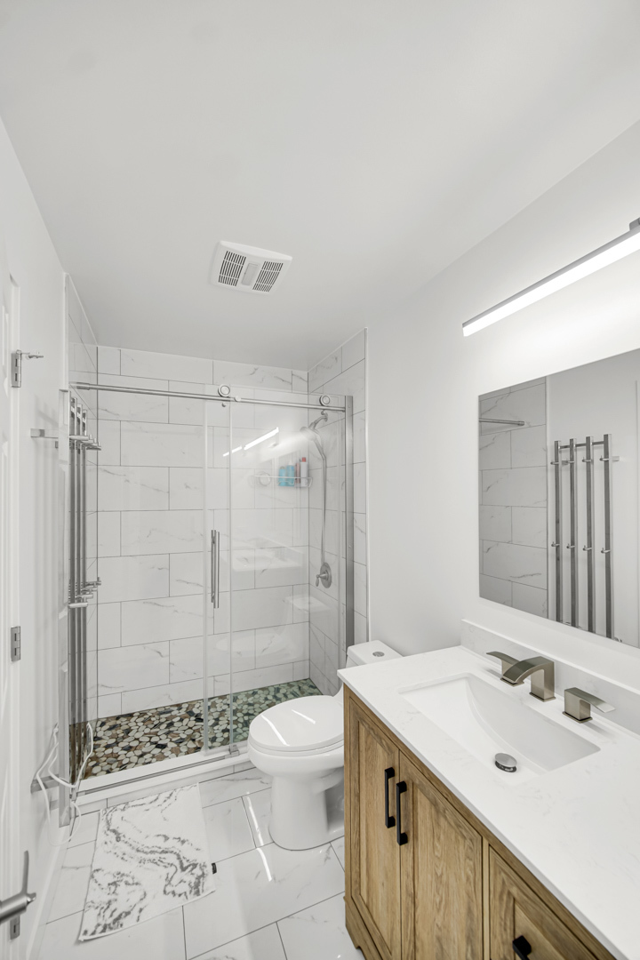 1485 Chippewa Trail Wheeling, IL 60090 - Photo 5 of 16 a bathroom with a sink toilet double vanity and shower