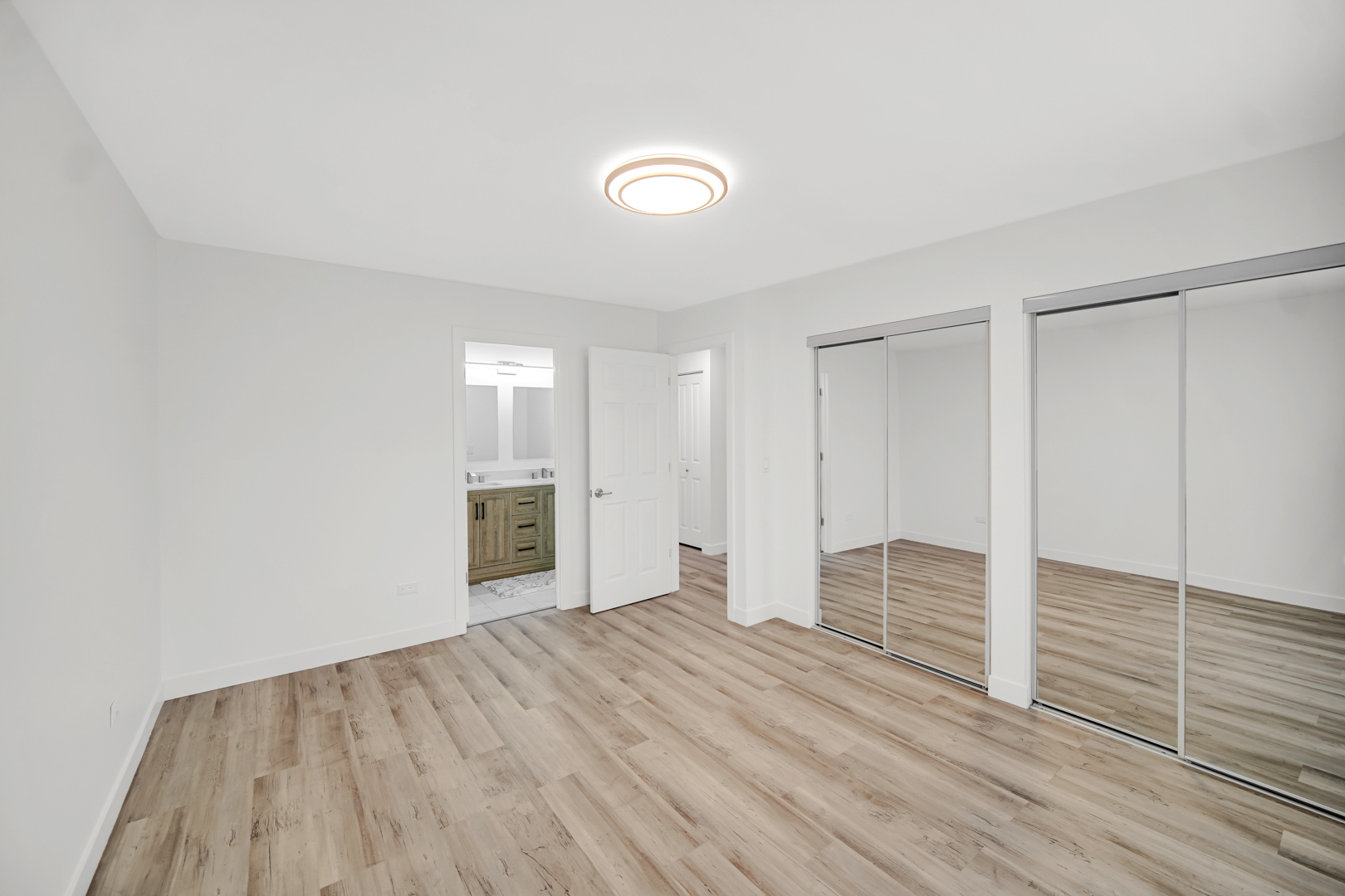 1485 Chippewa Trail Wheeling, IL 60090 - Photo 9 of 16 an empty room with wooden floor and windows