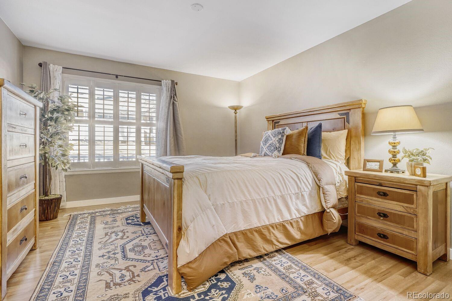 47 Canongate Lane Highlands Ranch, CO 80130 - Photo 13 of 22 a bedroom with a bed and a window
