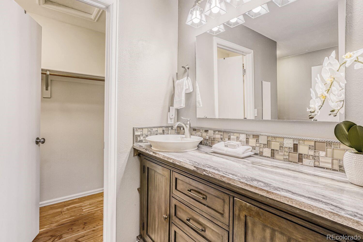47 Canongate Lane Highlands Ranch, CO 80130 - Photo 15 of 22 a bathroom with a sink and a mirror
