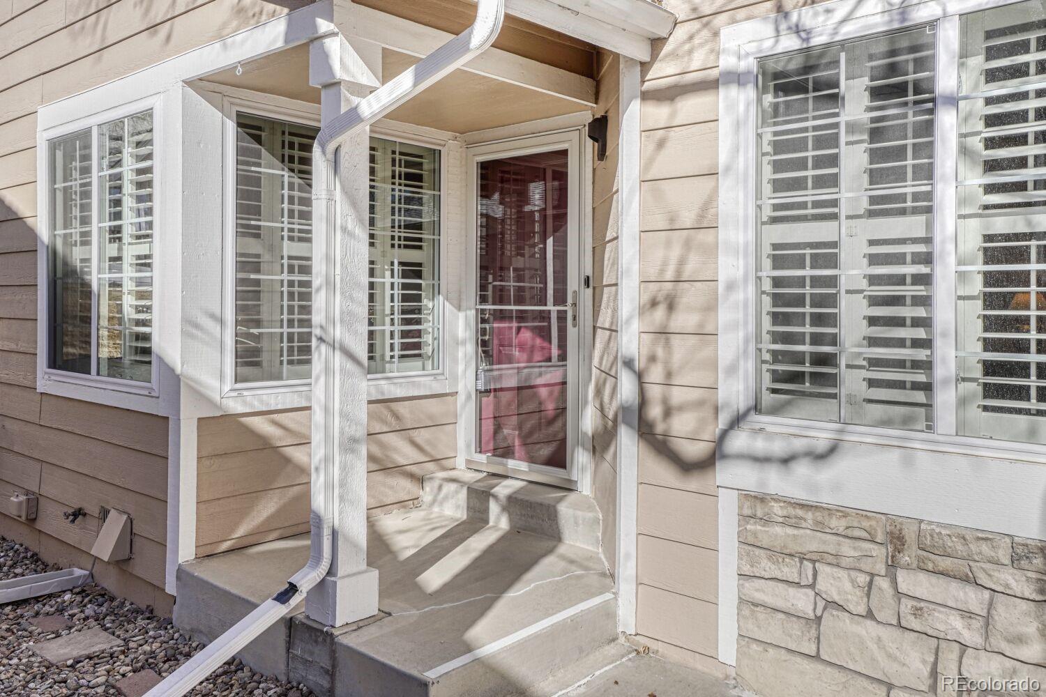 47 Canongate Lane Highlands Ranch, CO 80130 - Photo 3 of 22 a front view of a house with a glass door