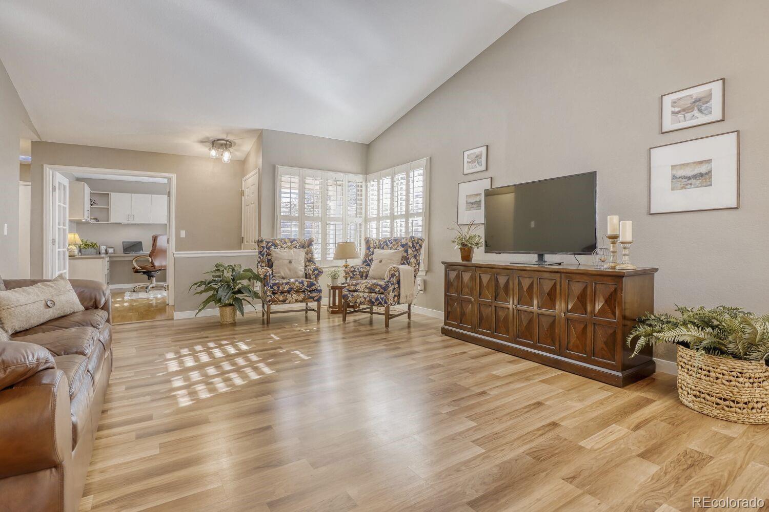 47 Canongate Lane Highlands Ranch, CO 80130 - Photo 7 of 22 a living room with furniture and a flat screen tv