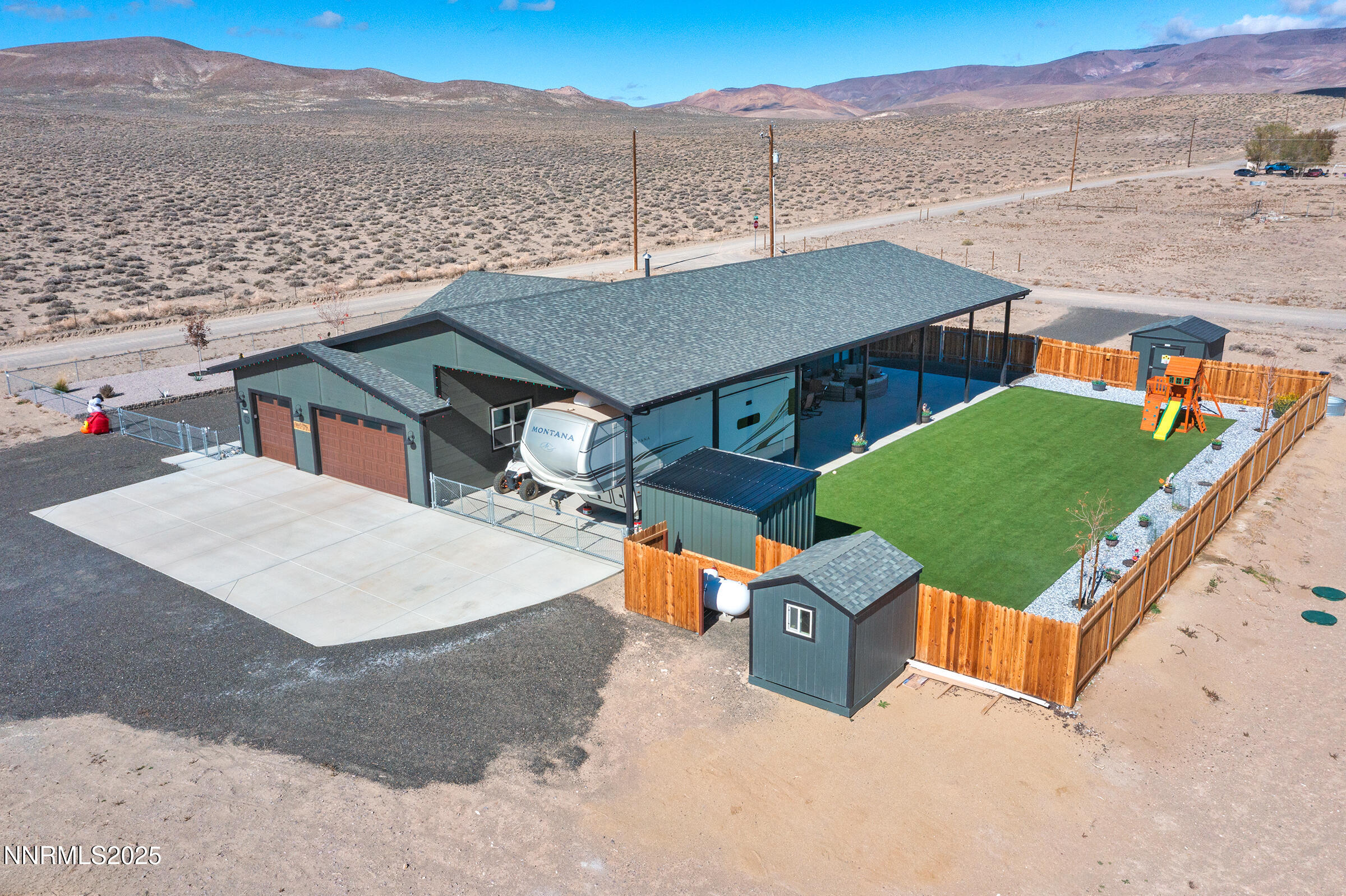 3900 Hackberry Street Silver Springs, NV 89429 - Photo 3 of 30 an aerial view of a house with a garden and lake view