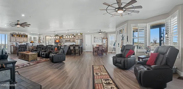 a living room with lots of furniture and wooden floor