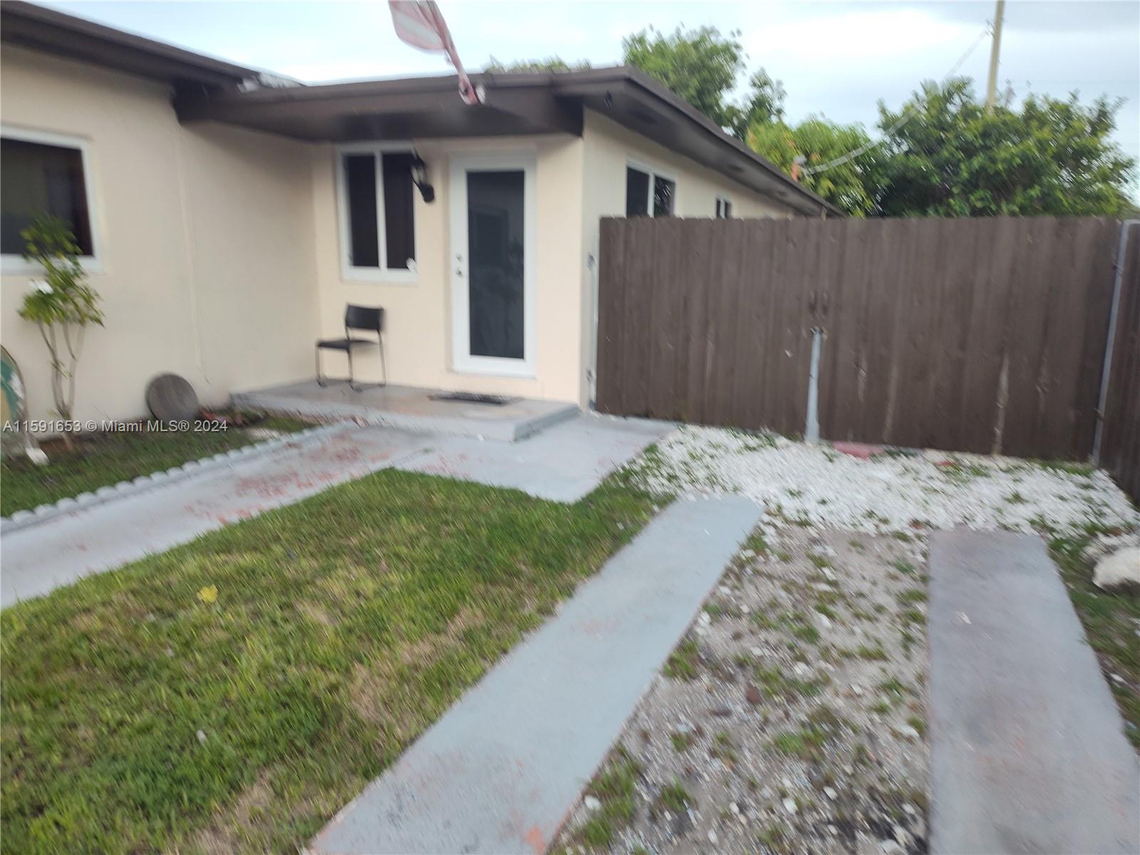 a front view of house with pathway and yard