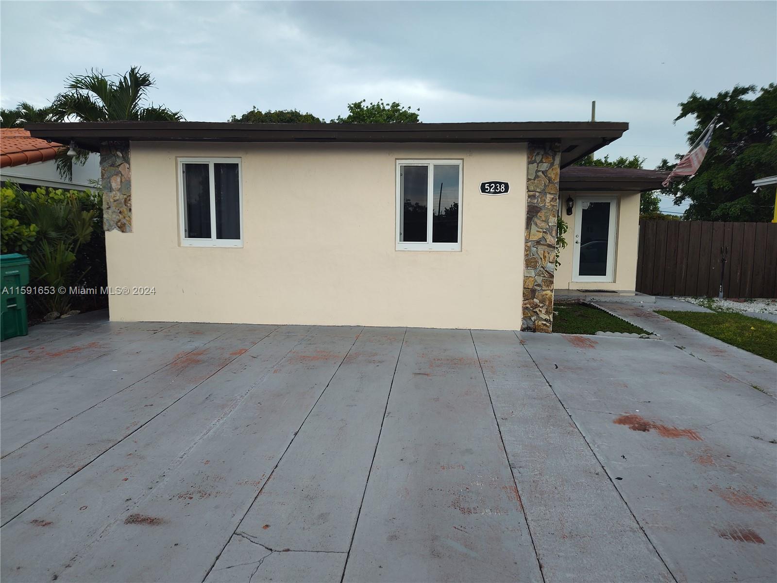 Flagami Miami, FL 33126 - Photo 3 of 3 a front view of a house with a yard and garage