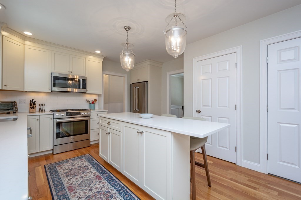 7 July Road Sudbury, MA 01776 - Photo 3 of 41 a kitchen with stainless steel appliances kitchen island granite countertop a stove top oven a sink a counter space and cabinets