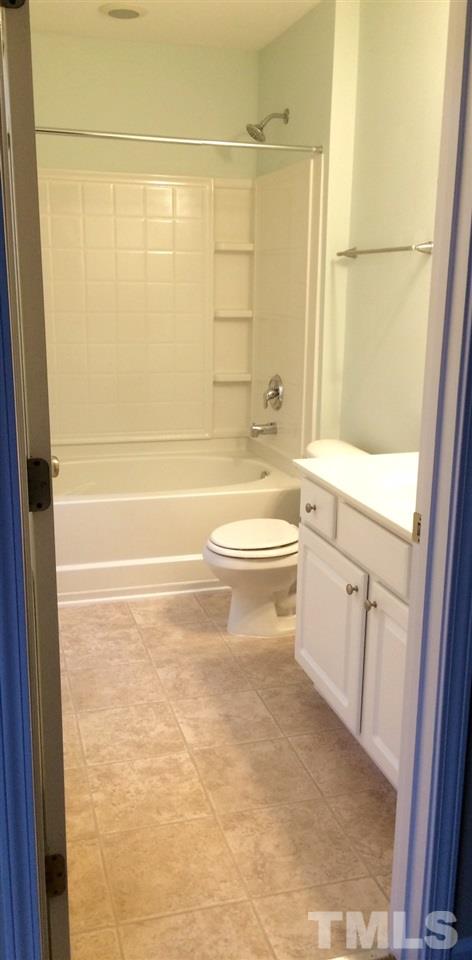 4112 Wyrick Court Raleigh, NC 27604 - Photo 13 of 18 a bathroom with a toilet a sink a shower and bathtub