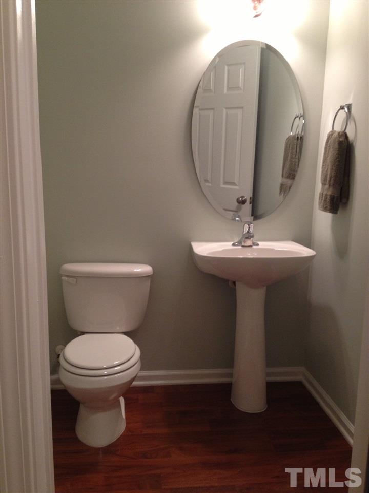 4112 Wyrick Court Raleigh, NC 27604 - Photo 9 of 18 a bathroom with a sink toilet and mirror