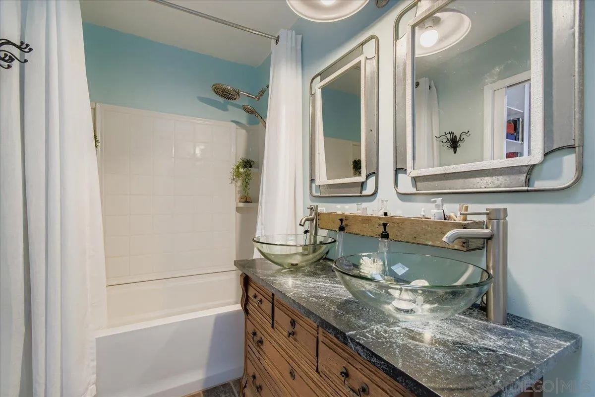 3275 East Virgo Road San Diego, CA 92105 - Photo 11 of 38 a bathroom with a granite countertop sink and a mirror