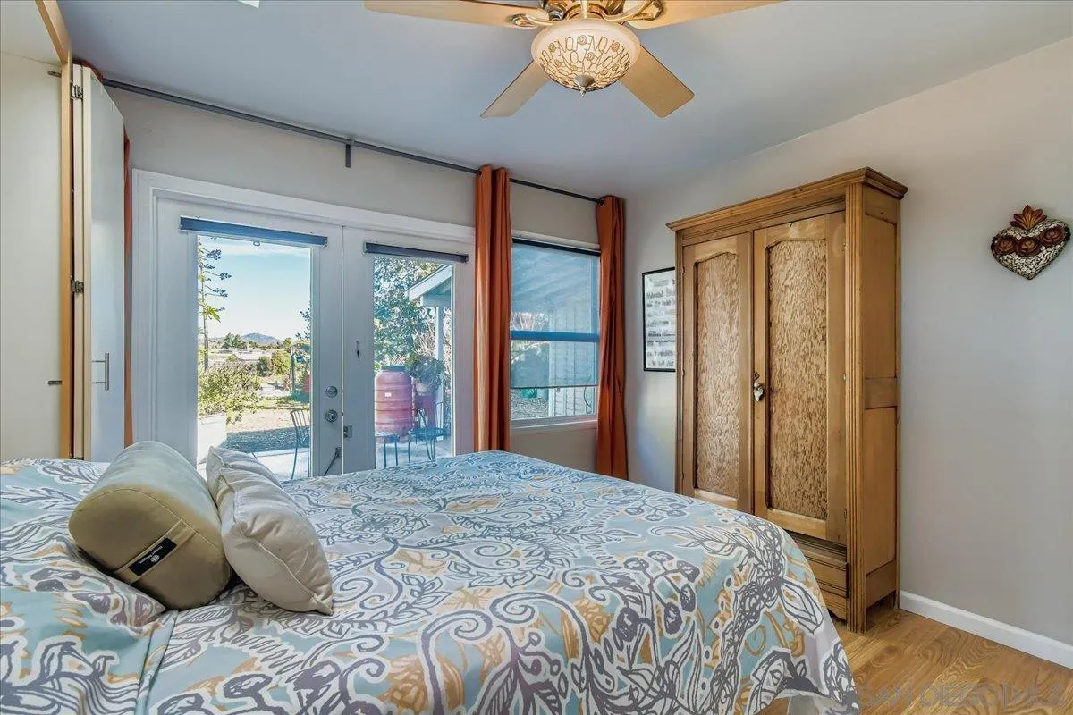 3275 East Virgo Road San Diego, CA 92105 - Photo 13 of 38 a bedroom with a large bed and a window