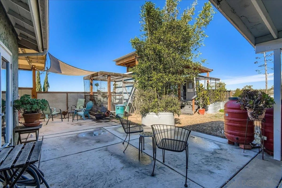 3275 East Virgo Road San Diego, CA 92105 - Photo 20 of 38 a view of a patio with a table and chairs and potted plants