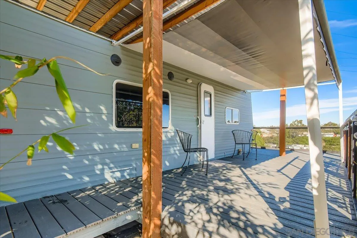 3275 East Virgo Road San Diego, CA 92105 - Photo 24 of 38 a view of a patio with wooden chairs