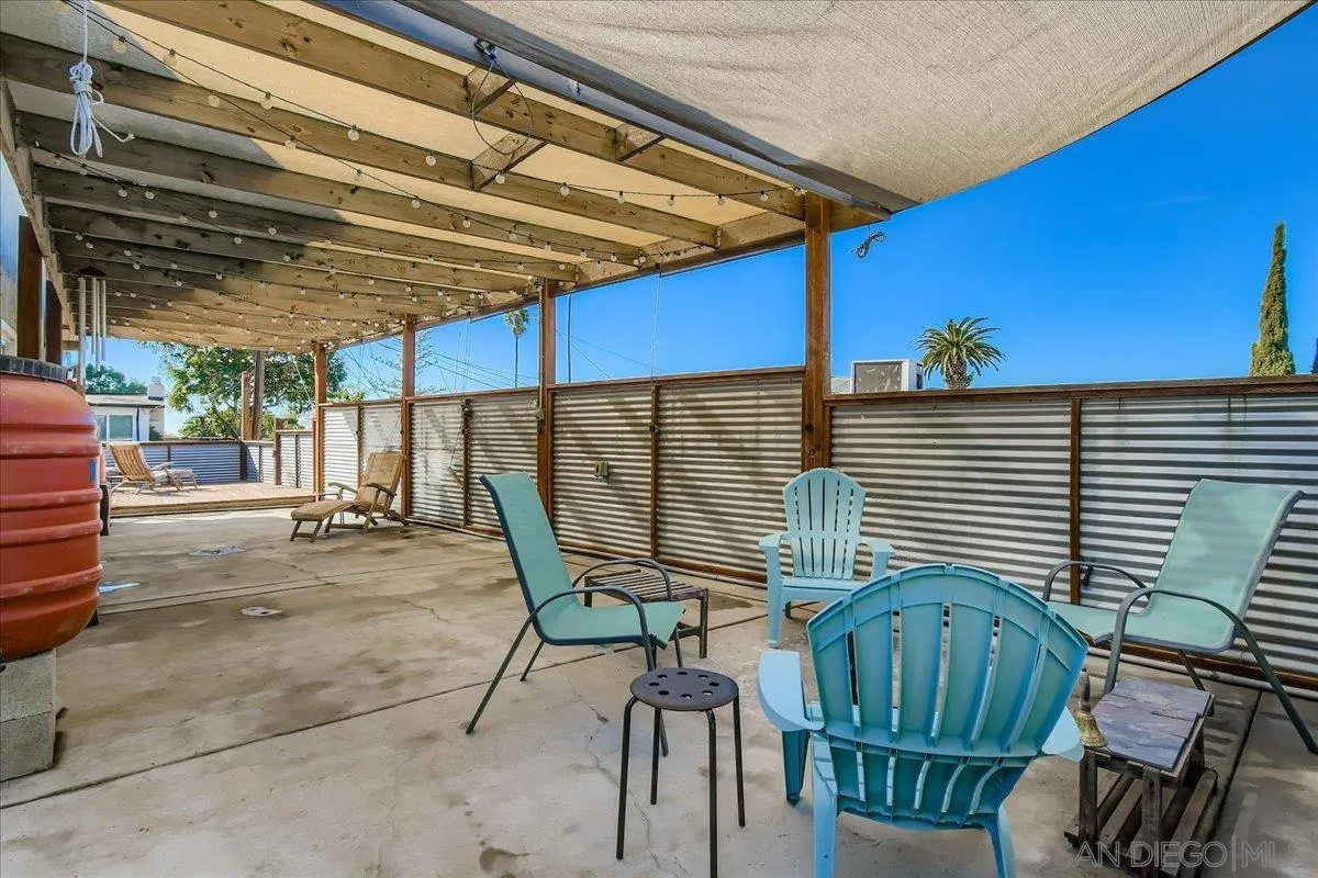 3275 East Virgo Road San Diego, CA 92105 - Photo 30 of 38 a view of a patio with table and chairs with wooden floor