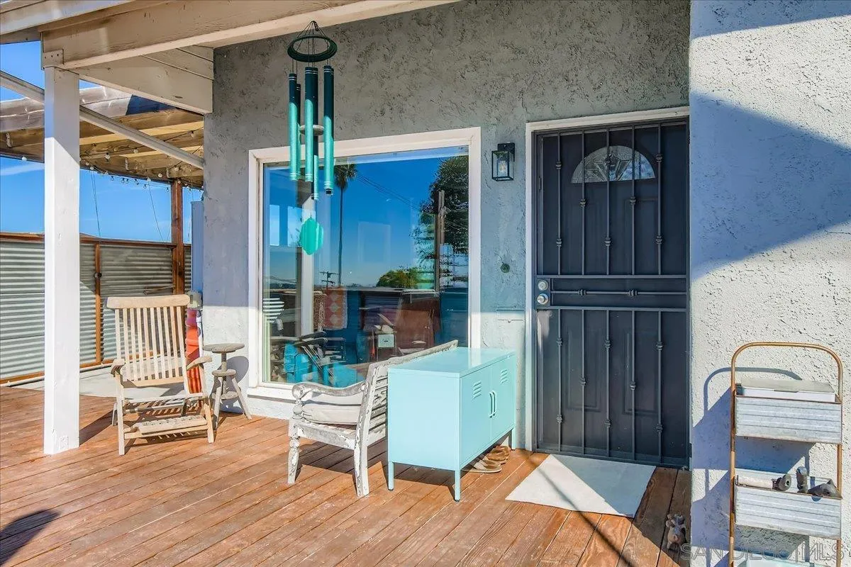3275 East Virgo Road San Diego, CA 92105 - Photo 32 of 38 a backyard of a house with wooden floor table and chairs