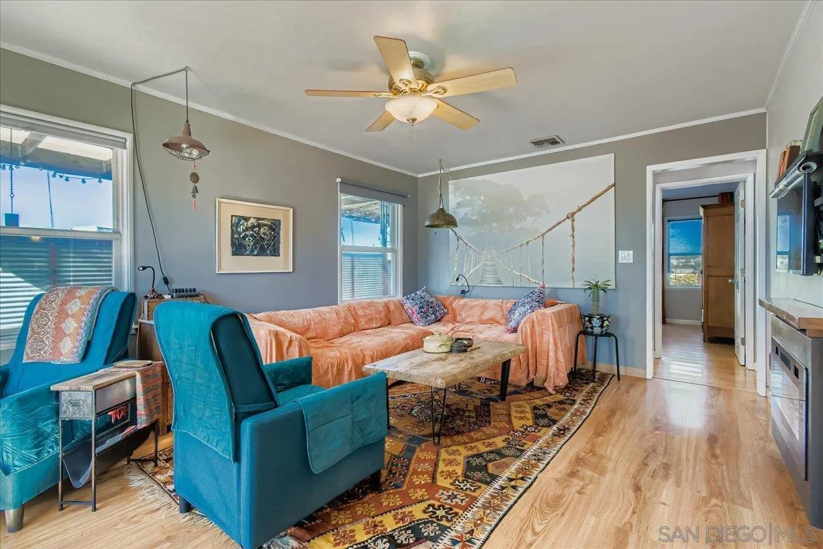 3275 East Virgo Road San Diego, CA 92105 - Photo 4 of 38 a living room with furniture and a wooden floor