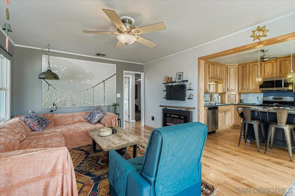 3275 East Virgo Road San Diego, CA 92105 - Photo 5 of 38 a living room with furniture a fireplace and a flat screen tv