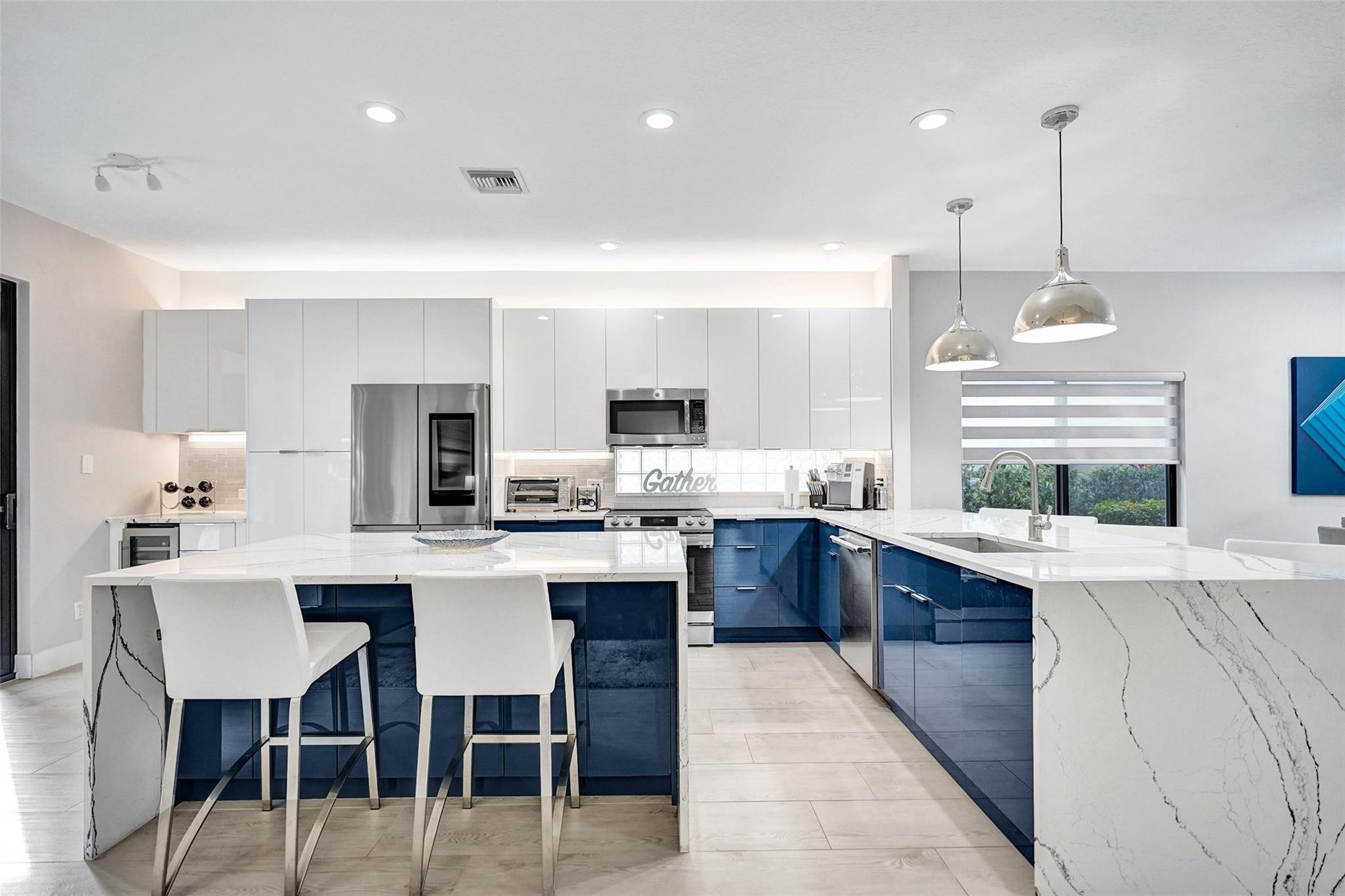 551 Anchor Point Delray Beach, FL 33444 - Photo 18 of 46 a kitchen with stainless steel appliances kitchen island granite countertop a sink and cabinets