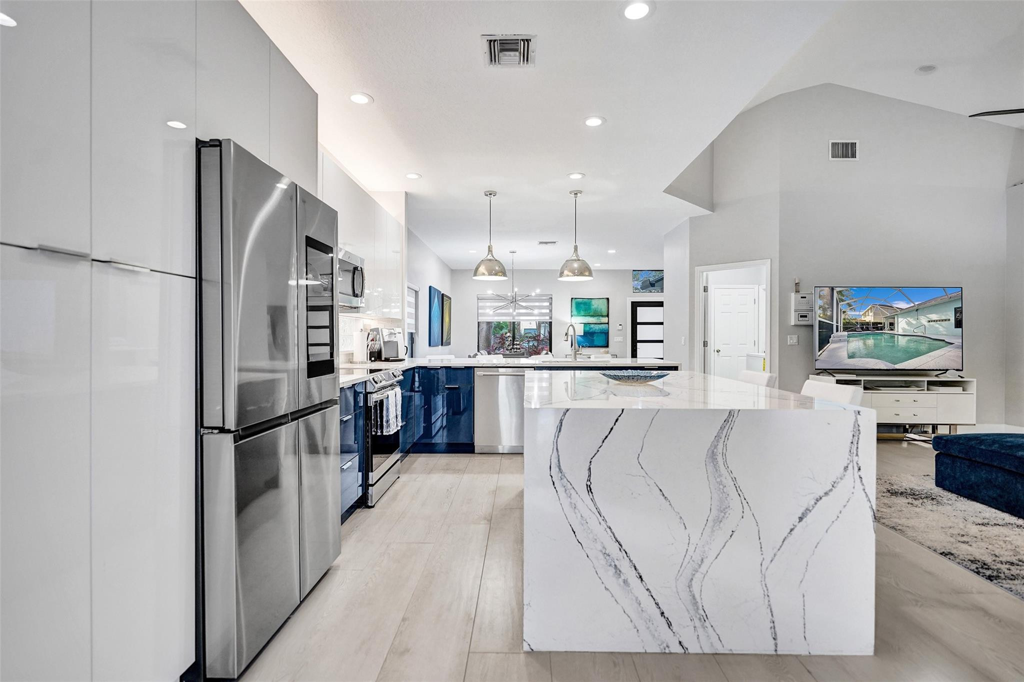 551 Anchor Point Delray Beach, FL 33444 - Photo 20 of 46 a kitchen with stainless steel appliances kitchen island granite countertop a refrigerator and cabinets