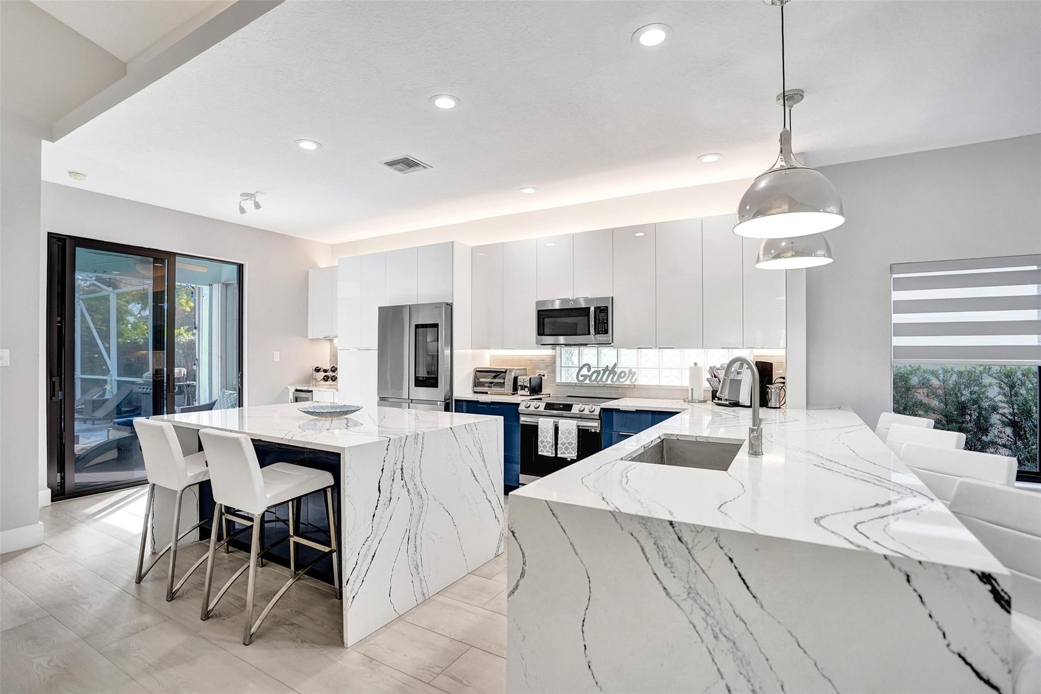 551 Anchor Point Delray Beach, FL 33444 - Photo 22 of 46 a kitchen that has a lot of cabinets a sink and appliances in it
