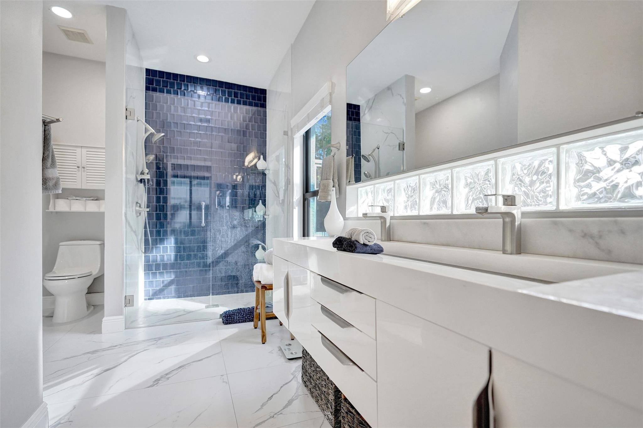 551 Anchor Point Delray Beach, FL 33444 - Photo 34 of 46 a bathroom with a double vanity sink toilet and shower