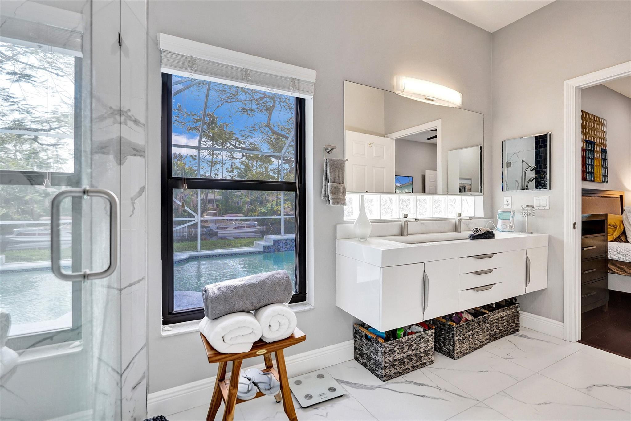 551 Anchor Point Delray Beach, FL 33444 - Photo 36 of 46 a bathroom with a double vanity sink bathtub and next to a window