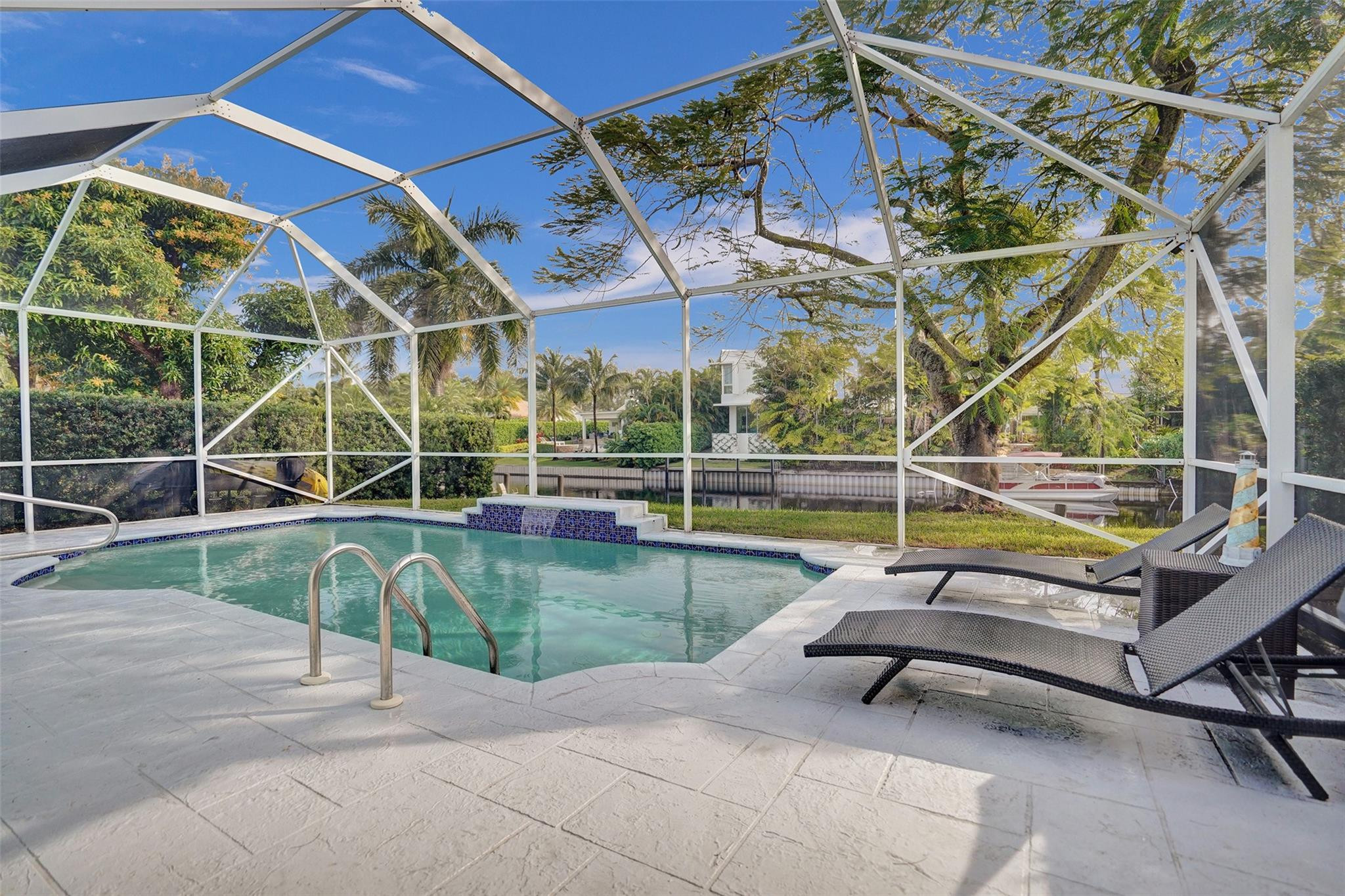 551 Anchor Point Delray Beach, FL 33444 - Photo 40 of 46 a view of a swimming pool with a bench and lawn chairs